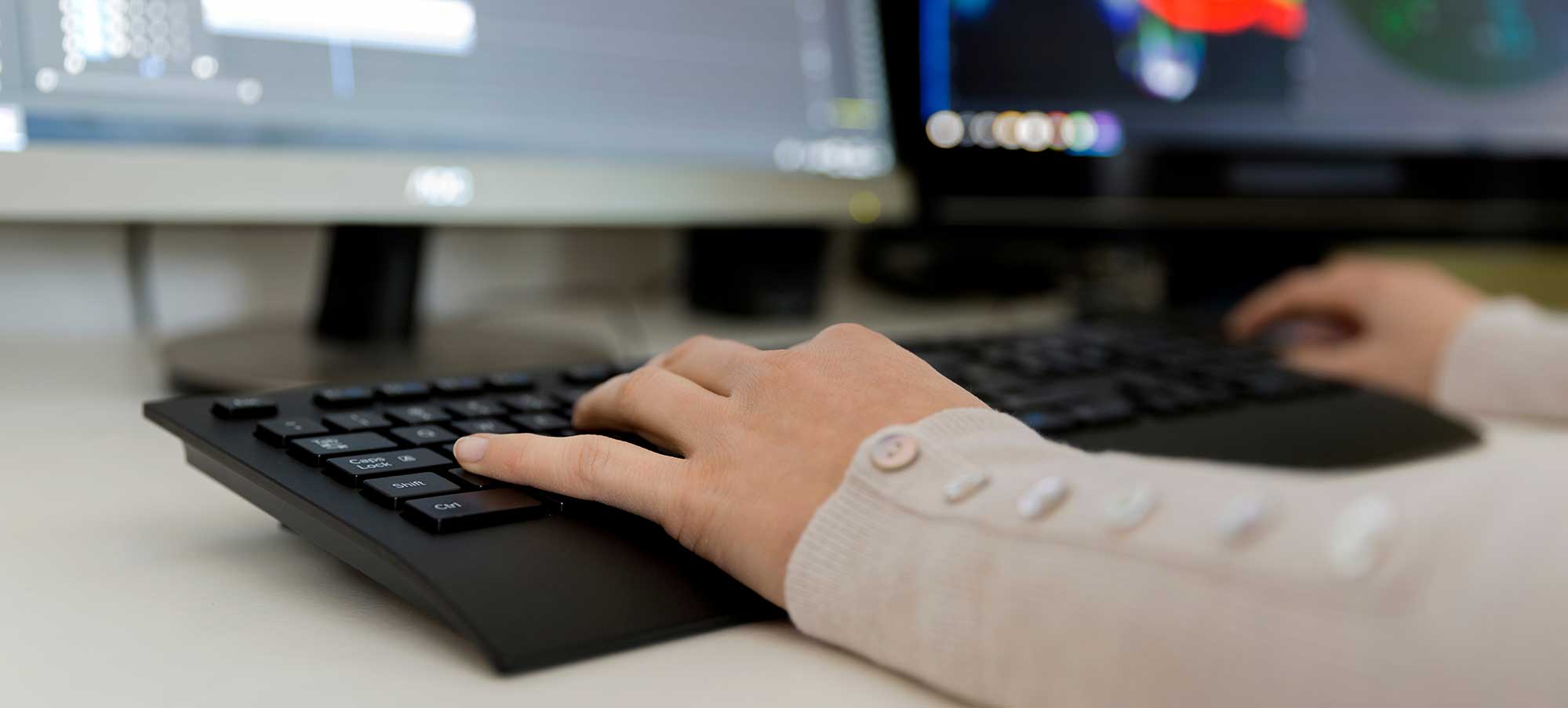 Person typing on keyboard
